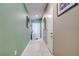 Hallway featuring white doors, tile flooring, and neutral decor at 680 Argyll Dr, Spring Hill, FL 34609