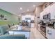 The open-concept kitchen is equipped with granite countertops, stainless steel appliances, and plenty of counter space at 680 Argyll Dr, Spring Hill, FL 34609