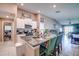 The spacious kitchen features an island with bar seating, granite countertops and is open to the living room at 680 Argyll Dr, Spring Hill, FL 34609
