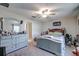 Serene main bedroom with neutral walls, soft carpet, ceiling fan, and ample natural light, perfect for relaxation at 680 Argyll Dr, Spring Hill, FL 34609