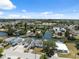 Aerial view shows neighborhood homes on canal featuring easy access to water and nearby streets at 6816 Sanderling Ln, Hudson, FL 34667
