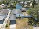 Aerial view of the neighborhood canal and home with a tiki hut in the backyard at 6816 Sanderling Ln, Hudson, FL 34667
