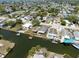 Aerial view featuring canal-front homes with docks and boat access, emphasizing waterfront charm at 6816 Sanderling Ln, Hudson, FL 34667