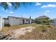 View of the home's backyard featuring a tiki hut, privacy fence and partial water view at 6816 Sanderling Ln, Hudson, FL 34667
