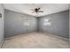 Bedroom with neutral walls, a ceiling fan, plank flooring, and natural light from two windows at 6816 Sanderling Ln, Hudson, FL 34667