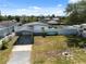 Exterior shot showcasing the home's fenced in yard, boat, carport and backyard tiki hut at 6816 Sanderling Ln, Hudson, FL 34667