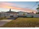 Charming single-story home featuring a carport and well-maintained lawn at sunset at 6816 Sanderling Ln, Hudson, FL 34667