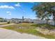 Charming single-story home featuring well-maintained lawn, carport and partially fenced yard at 6816 Sanderling Ln, Hudson, FL 34667