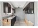 Kitchen with dark cabinets, stainless steel sink, and natural light, ready for updates at 6816 Sanderling Ln, Hudson, FL 34667