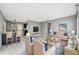 Inviting living room featuring cozy seating and an open layout to kitchen with a breakfast bar at 6816 Sanderling Ln, Hudson, FL 34667