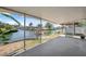 Enclosed patio overlooks scenic waterfront with lush greenery and clear blue skies at 6816 Sanderling Ln, Hudson, FL 34667