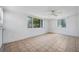 Bright living room with neutral paint, tile floors, and a ceiling fan at 7401 Potomac Dr, Port Richey, FL 34668