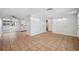 Open-concept living room with tiled flooring, neutral walls, and great lighting at 7401 Potomac Dr, Port Richey, FL 34668