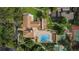 Aerial view of community pool with surrounding amenities including tennis and shuffleboard courts at 7529 Greystone Dr # A, Hudson, FL 34667