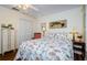 Cozy bedroom featuring a floral bed, a closet, and lighting at 7529 Greystone Dr # A, Hudson, FL 34667