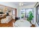Bright breakfast nook featuring large windows and seamless flow into a cozy living space with floral decor at 7529 Greystone Dr # A, Hudson, FL 34667
