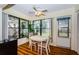 Sunlit dining area with many windows, a ceiling fan and seating at 7529 Greystone Dr # A, Hudson, FL 34667