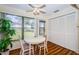 Sunlit dining area with a table, seating, and outdoor views at 7529 Greystone Dr # A, Hudson, FL 34667