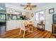 Dining area with wood-look flooring, ceiling fan, and view into kitchen at 7529 Greystone Dr # A, Hudson, FL 34667