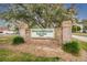 Beacon Woods Golf Club entrance sign amongst a backdrop of mature trees at 7529 Greystone Dr # A, Hudson, FL 34667