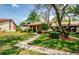 Charming single-story home with a lush green lawn, mature trees, and well-manicured landscaping at 7529 Greystone Dr # A, Hudson, FL 34667