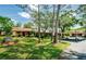 Well-maintained single-story home with lush landscaping, a carport, and ample parking at 7529 Greystone Dr # A, Hudson, FL 34667