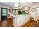 Functional kitchen with a breakfast bar, black appliances, and wood-look flooring at 7529 Greystone Dr # A, Hudson, FL 34667