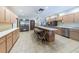 A large kitchen features ample cabinetry, stainless steel appliances, and a breakfast bar at 7529 Greystone Dr # A, Hudson, FL 34667