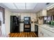 Bright kitchen with updated appliances, lighting, and faux wood flooring at 7529 Greystone Dr # A, Hudson, FL 34667
