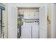 Functional laundry closet featuring a washer, dryer, and storage at 7529 Greystone Dr # A, Hudson, FL 34667