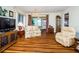 Living room with wood-look floors and a view into dining area at 7529 Greystone Dr # A, Hudson, FL 34667