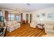 Spacious living room with a view to the dining room, showcasing an open floor plan at 7529 Greystone Dr # A, Hudson, FL 34667