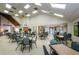 A well lit meeting room with a high ceiling, with tables and chairs arranged throughout at 7529 Greystone Dr # A, Hudson, FL 34667