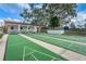 Community shuffleboard courts with covered seating and a view to the basketball court at 7529 Greystone Dr # A, Hudson, FL 34667