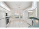 Bright kitchen with white cabinets, modern appliances, and tile flooring at 8445 Gallup Rd, Spring Hill, FL 34608
