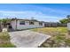 Back exterior of home featuring a yard and view of the back patio at 9001 Lido Ln, Port Richey, FL 34668