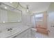 Vintage bathroom with a large mirror, vanity and sink, and a pink tiled bathtub at 9001 Lido Ln, Port Richey, FL 34668
