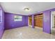 Spacious bedroom with tile floors, natural light, and wooden closet with an open door to the hallway at 9001 Lido Ln, Port Richey, FL 34668
