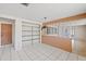 The open dining room offers built in shelving, tile floor, and a vintage light fixture at 9001 Lido Ln, Port Richey, FL 34668