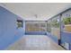 Enclosed Florida room with large windows offering plenty of natural light and tiled floor at 9001 Lido Ln, Port Richey, FL 34668