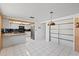 The open kitchen has white cabinets, black appliances, and a granite countertop at 9001 Lido Ln, Port Richey, FL 34668