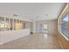 Bright living room with tile floors, decorative wall, and large window at 9001 Lido Ln, Port Richey, FL 34668