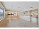 Open living room with tile floors, decorative half wall, and a view of kitchen at 9001 Lido Ln, Port Richey, FL 34668