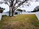 Large fenced backyard is perfect for entertaining with trees and lush landscaping at 9089 Dupont Ave, Spring Hill, FL 34608