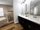 Bathroom with a double vanity, tile accents, modern fixtures, and wood-look floors at 9089 Dupont Ave, Spring Hill, FL 34608