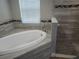 A luxurious bathroom showcases a modern soaking tub, walk-in shower and decorative tile details at 9089 Dupont Ave, Spring Hill, FL 34608