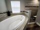 Bathroom with a large soaking tub and tiled shower, providing a luxurious bathing experience at 9089 Dupont Ave, Spring Hill, FL 34608