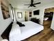 Bedroom boasts wood-look floors, a ceiling fan and backyard access through glass doors at 9089 Dupont Ave, Spring Hill, FL 34608
