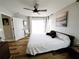 Bedroom boasts wood-look floors, a ceiling fan and backyard access through glass doors at 9089 Dupont Ave, Spring Hill, FL 34608