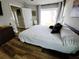 Bedroom features wood-look floors, a ceiling fan and backyard access through glass doors at 9089 Dupont Ave, Spring Hill, FL 34608